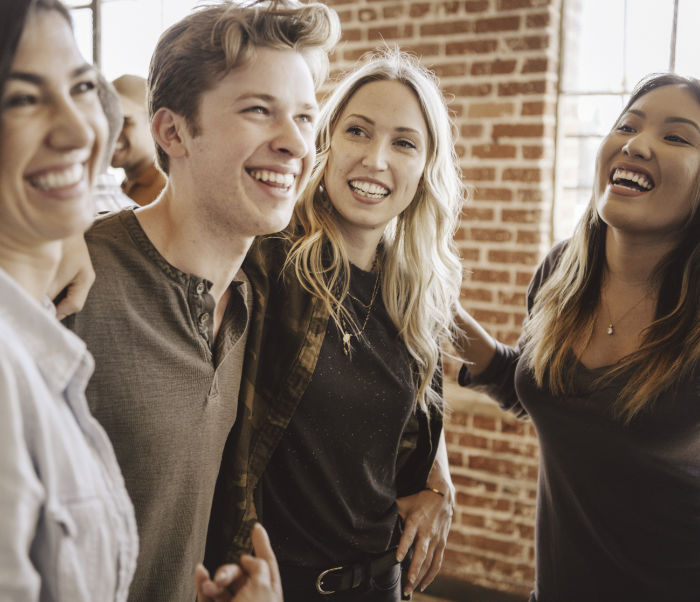 A laughing group of young people in a secondary school or college